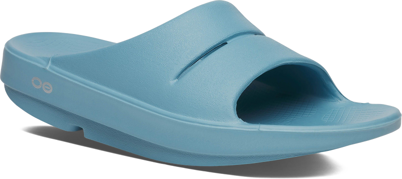 Quarter turn view Women's Oofos Footwear style name Ooahh Slide in color Ocean Blue. Sku: 1100OCEBLU